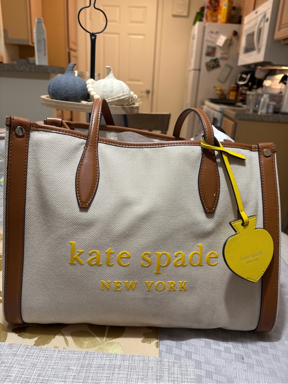 kate spade Cream Canvas Tote with Brown Leather Trim and Yellow Logo Charm